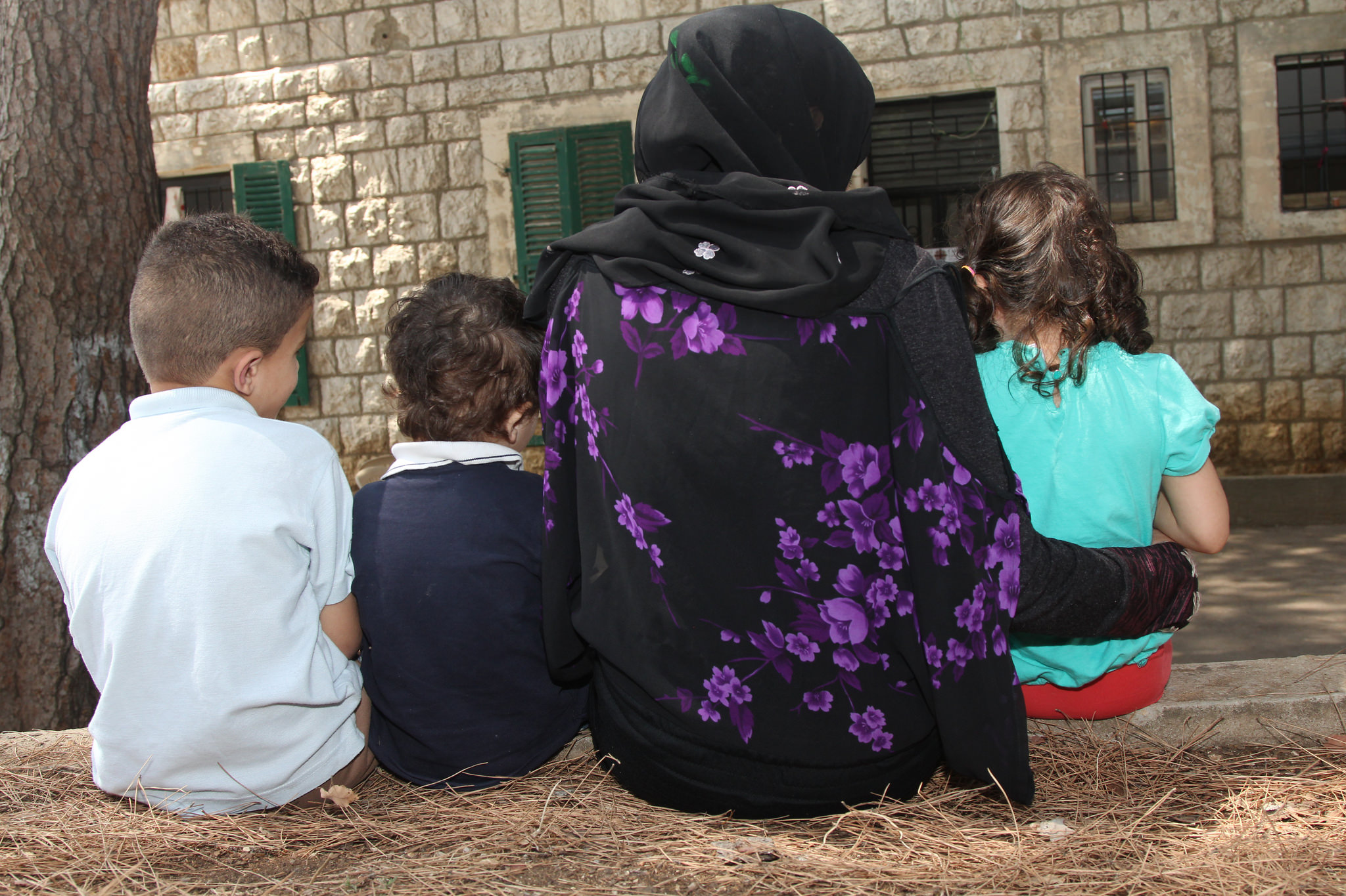 A Syrian refugee family outside the Catholic Relief Services (CRS)-supported shelter for Syrian refugee women who are victims of sexual and gender-based violence. Nikki Gamer / Catholic Relief Services