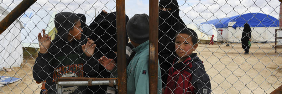Wives and children of former ISIS fighters gather at the fence in the foreign section of the al-Hawl refugee camp in northern Syria, waiting to be taken to the camp shops, April 2, 2019. . Photo:  Kate Geraghty/Getty Images