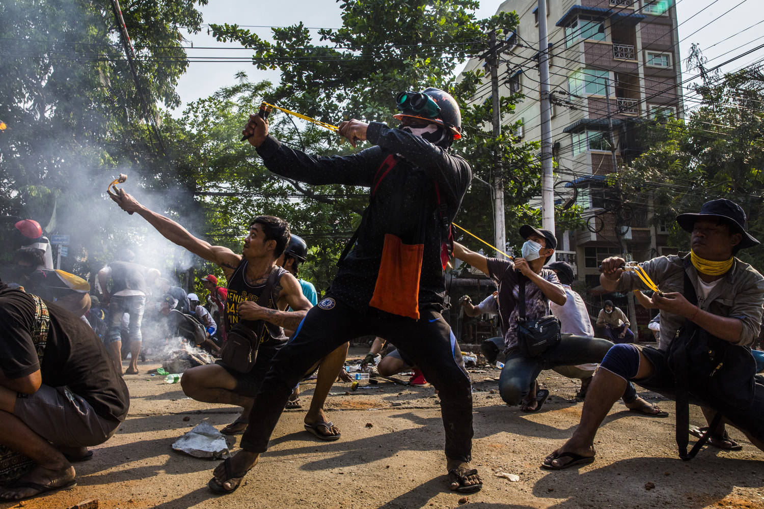 Protesters use slingshots during a clash with security forces in the Thaketa Township of Yangon, Myanmar, 28 March 2021.