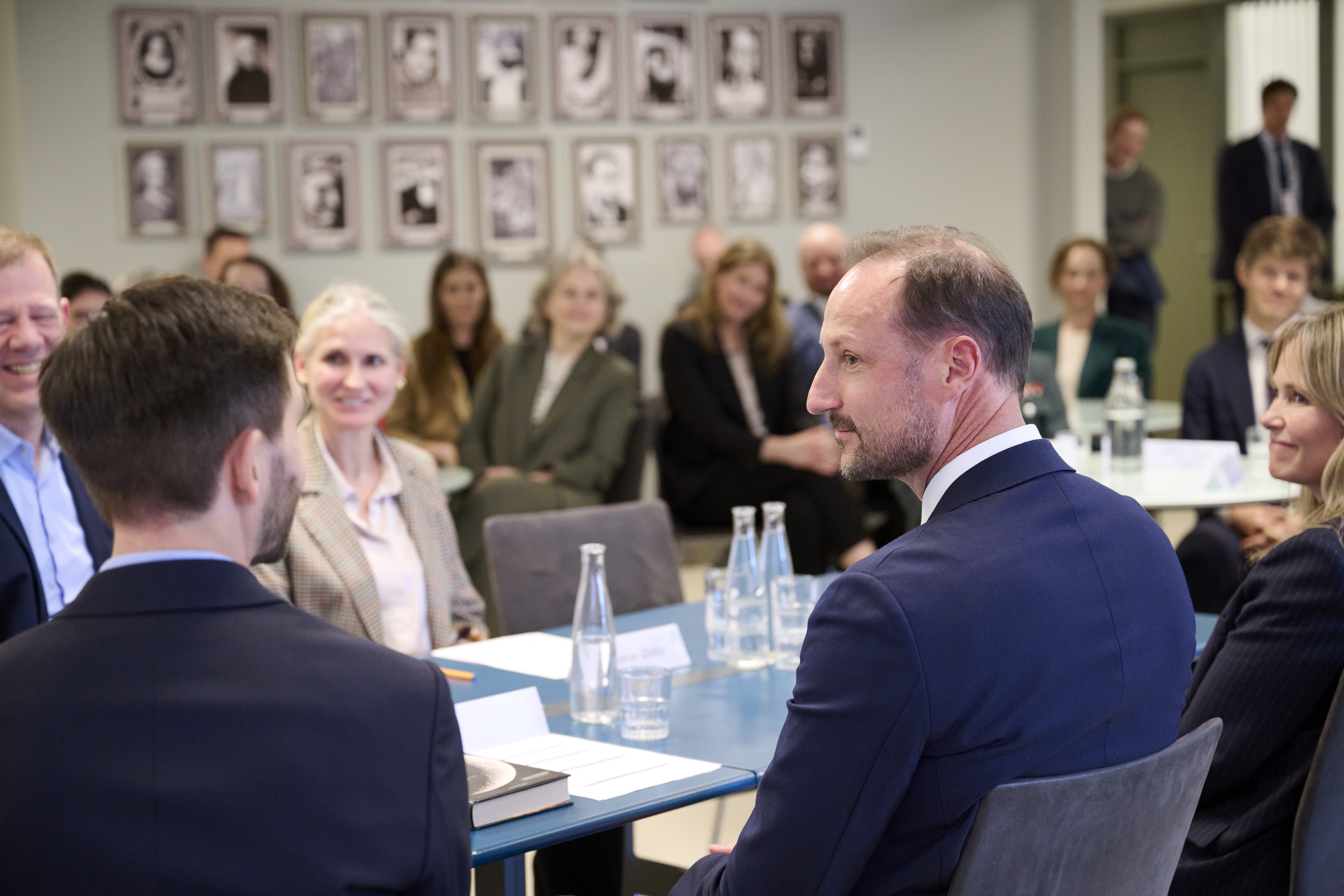 The Crown Prince of Norway is briefed by PRIO researchers on global migration and the impact of conflict on children. Photo: PRIO/Helle Moos