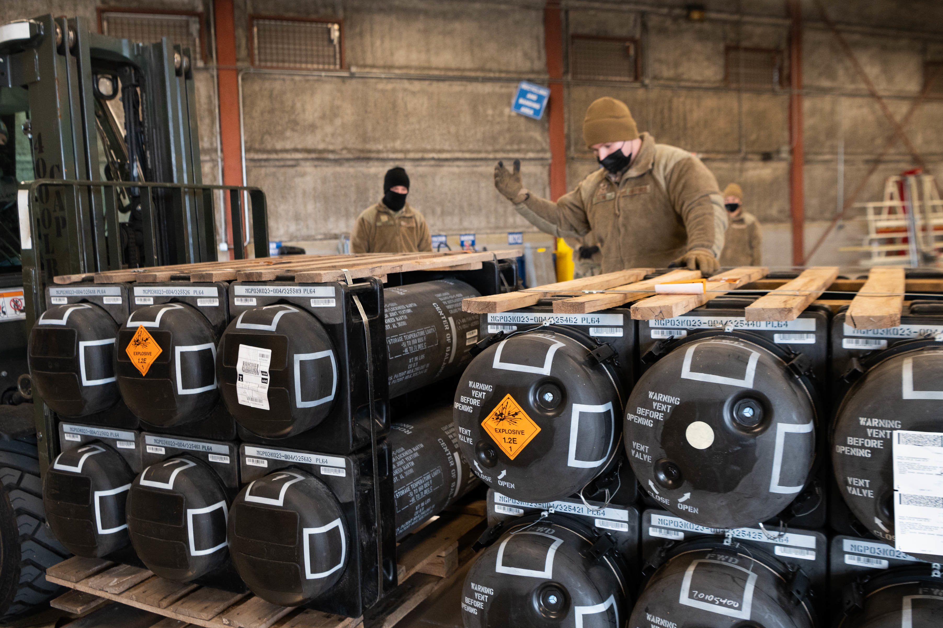 Airmen and civilians at Dover Air Force Base, Del., palletize ammunition, weapons and other equipment bound for Ukraine, Jan. 21, 2022. U.S. Air Force photo / Mauricio Campino