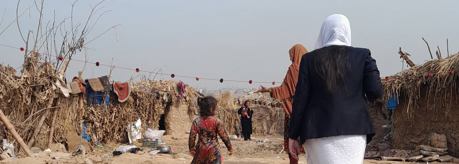 A lawyer working for a refugee and migrants support NGO is being shown the living conditions of a refugee village in Islamabad, Pakistan. Photo: Arjumand Bano Kazmi