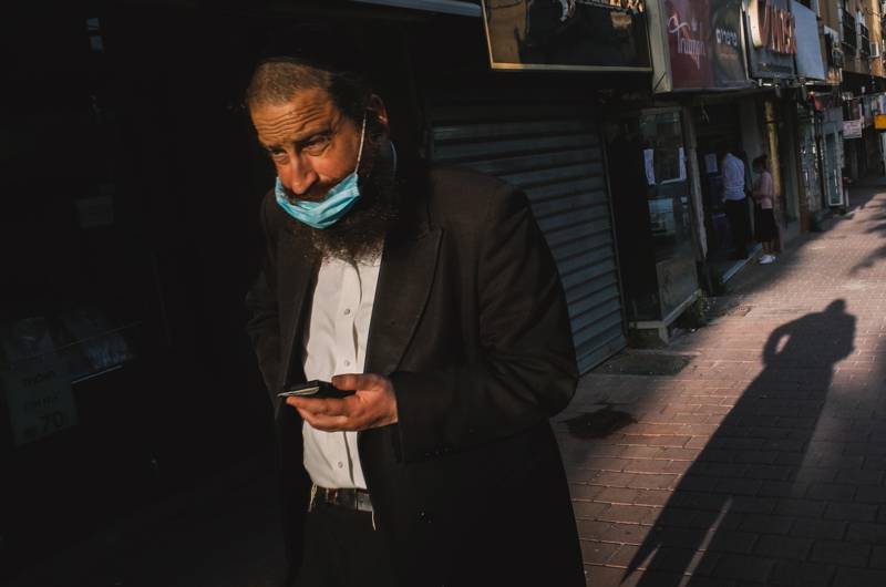 A man walks the streets of Bnei-Brak during the coronavirus shutdown. amir appel via Flickr CC BY