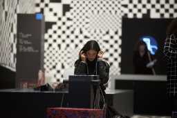 A woman is listening to an AI at an AI exhibition in Toulouse. Photo: Alain Pitton/NurPhoto via Getty Images
