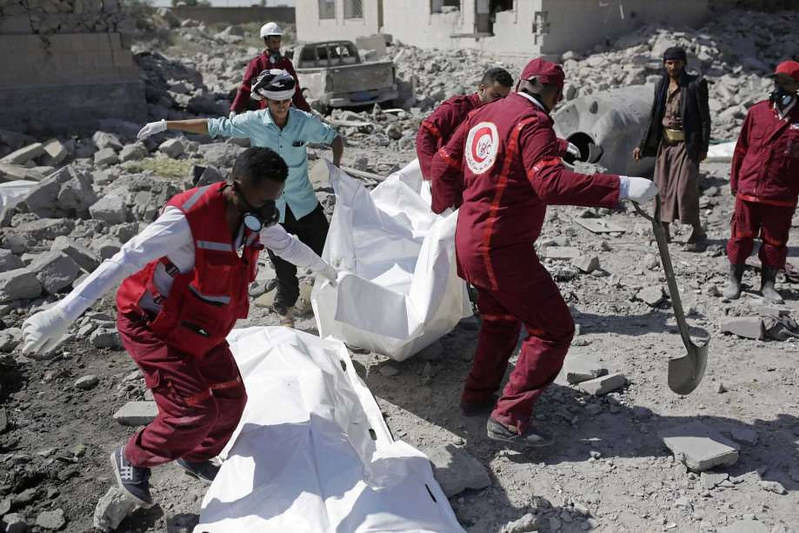 Rescue workers recover bodies from under the rubble of a Houthi detention center destroyed by Saudi-led airstrikes, that killed at least 60 people and wounding several dozen according to officials and the rebels' health ministry, in Dhamar province.