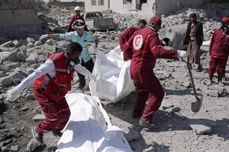 Rescue workers recover bodies from under the rubble of a Houthi detention center destroyed by Saudi-led airstrikes, that killed at least 60 people and wounding several dozen according to officials and the rebels' health ministry, in Dhamar province.