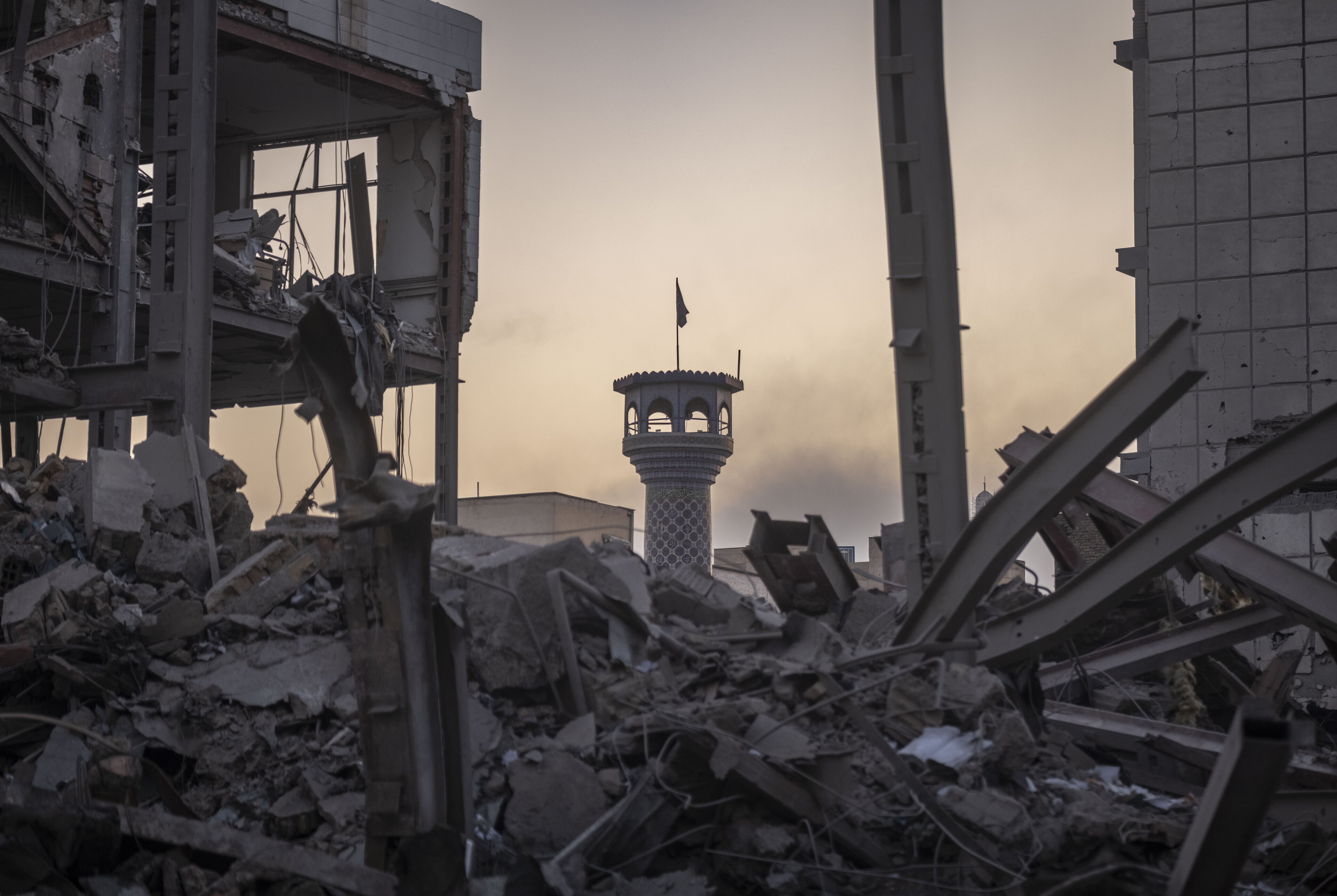 The minaret of a mosque is visible behind the ruins of a police headquarters that is completely destroyed in U.S.-Israeli attacks in Tehran, Iran, on March 2, 2026.
. Photo: Morteza Nikoubazl/NurPhoto via Getty Images