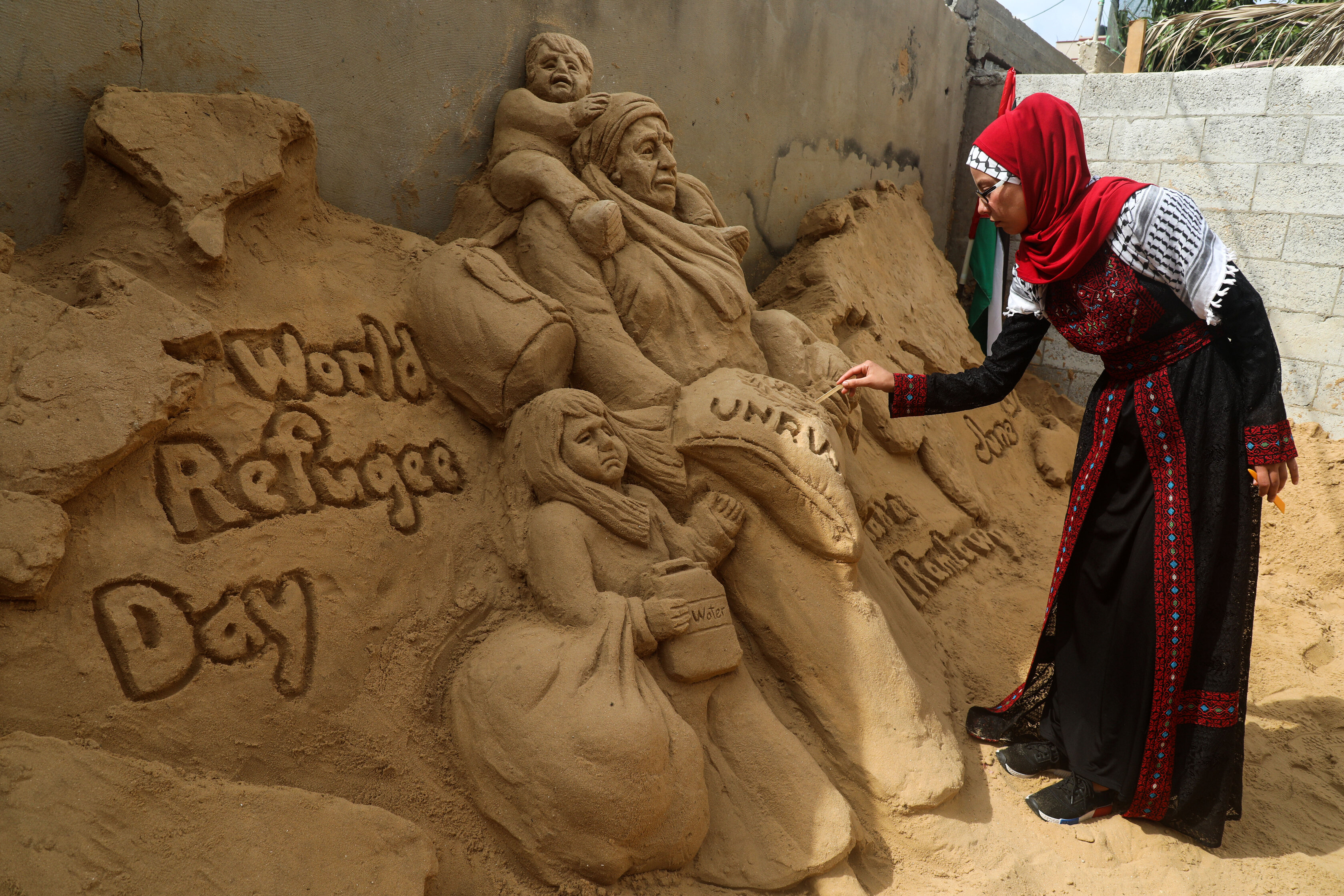 A Palestinian sand sculptor  commemorating World Refugee Day in Gaza City in June 2020. Majdi Fathi/NurPhoto via Getty Images