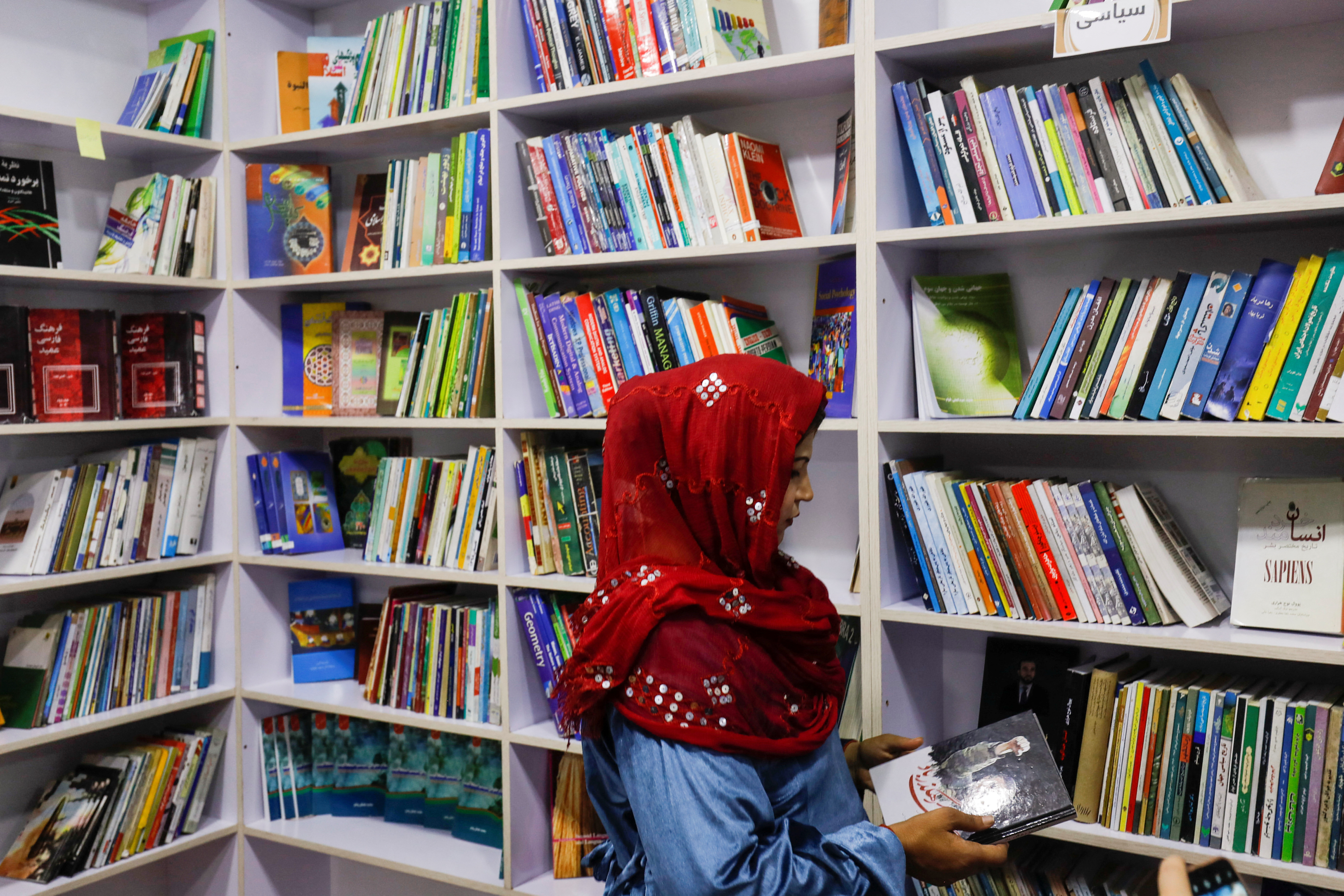An Afghan woman attends the inauguration of women's library in Kabul, Afghanistan, August 24, 2022. REUTERS/Ali Khara.