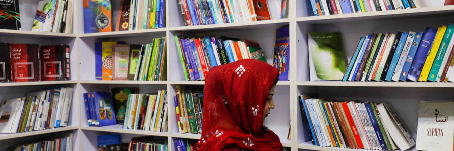 An Afghan woman attends the inauguration of women's library in Kabul, Afghanistan, August 24, 2022. REUTERS/Ali Khara.