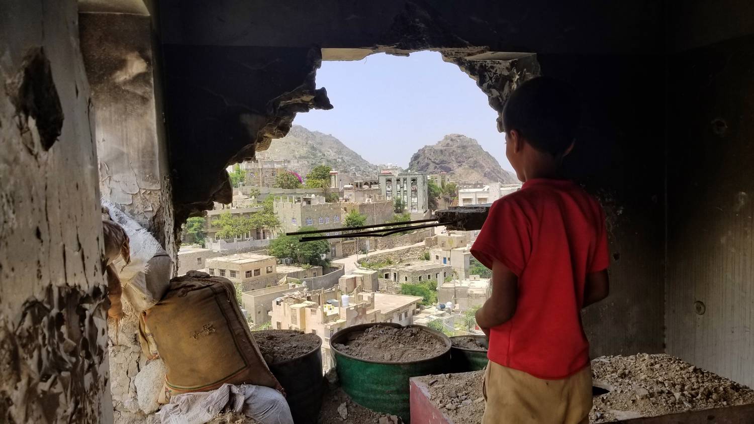 Child inspects their destroyed house due to the war in Yemen. Photo: Copyright (c) 2018 anasalhajj/Shutterstock