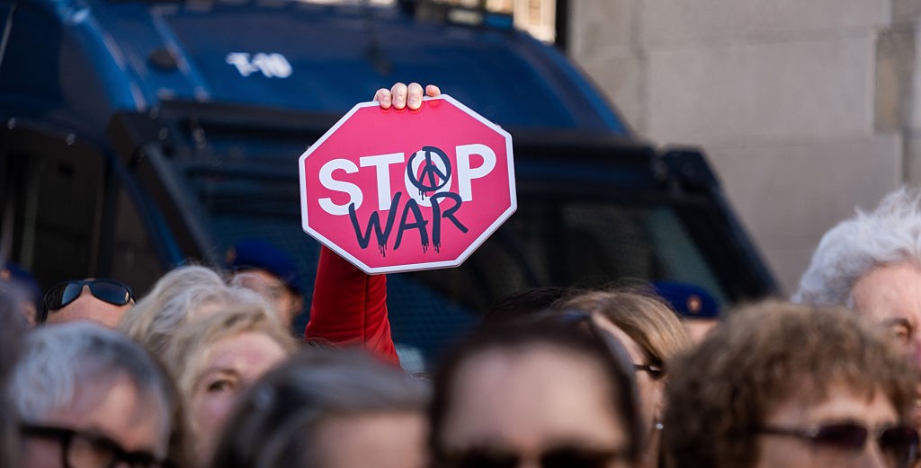 A protestor holds up a sign during a rally in Spain for the end to the war in Palestine. Photo: Getty Images