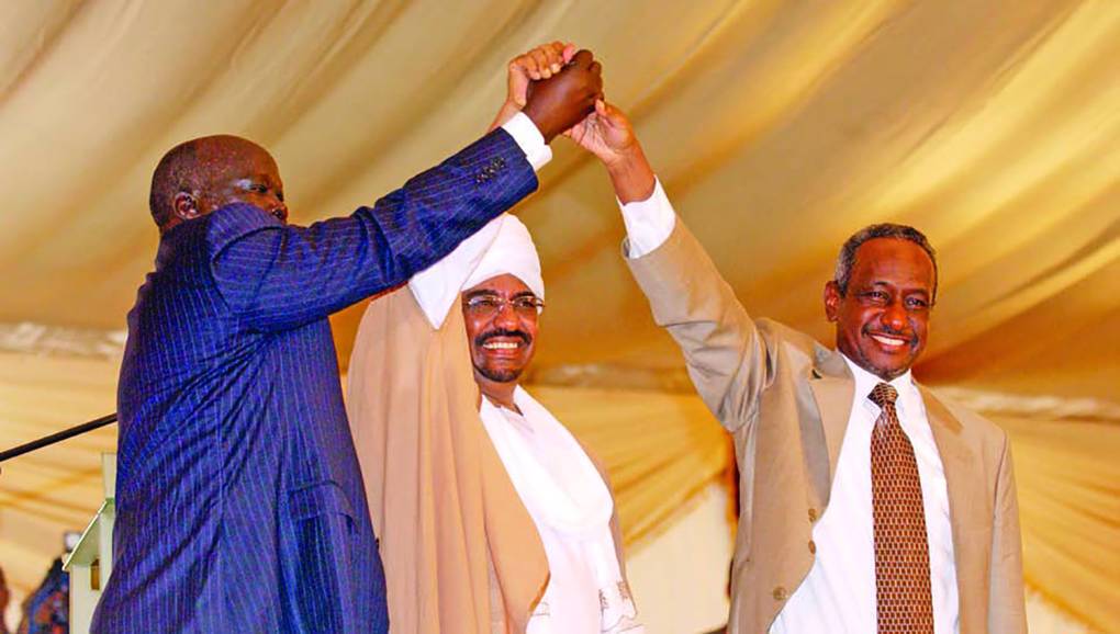 Sudanese leaders hold their hands in a symbolic gesture of unity. Photo: UN Photo / Evan Schneider