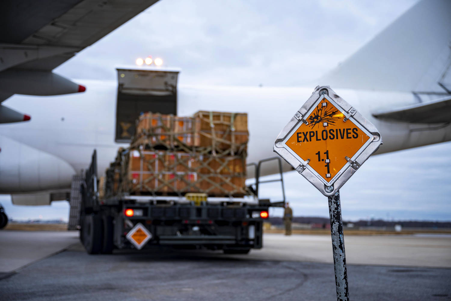 An explosives sign marks the cordon around a commercial aircraft during a security assistance mission at Dover Air Force Base, Del., Jan. 13, 2023. The United States has committed more than $24.5 billion in security assistance to Ukraine since the beginni.