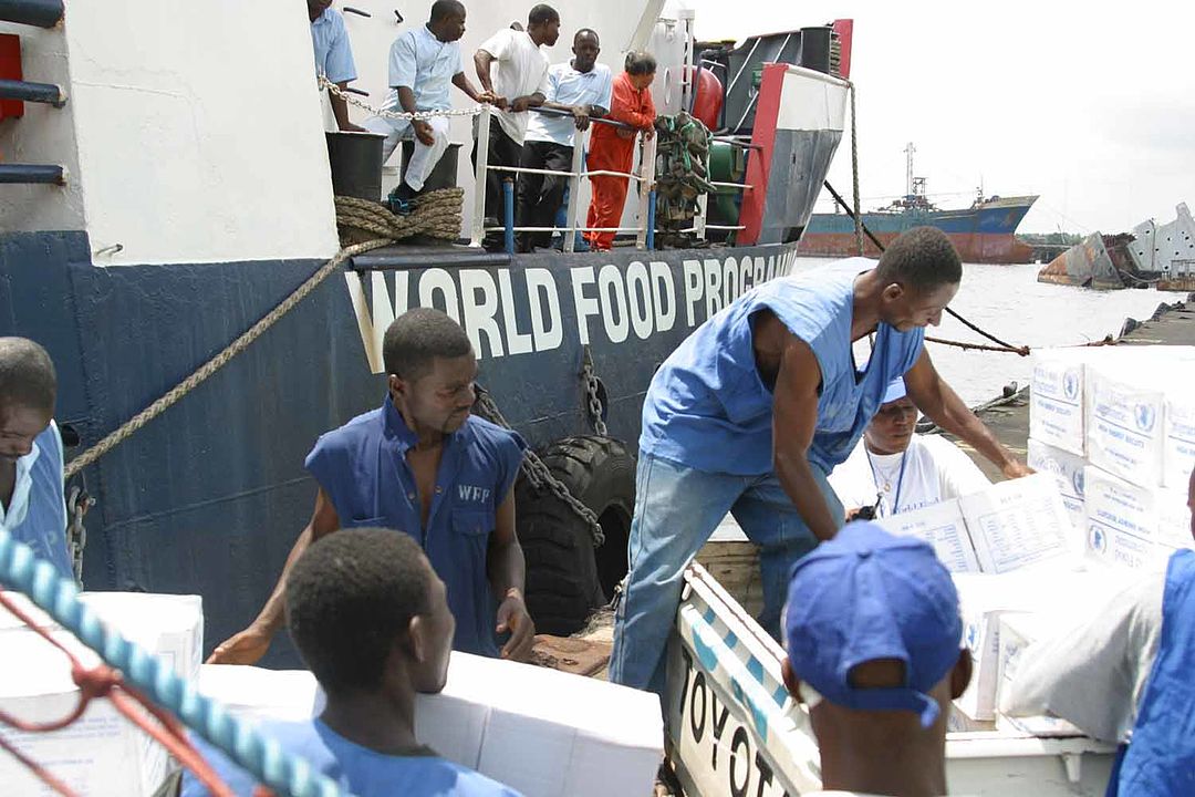 A World Food Programme ship with workers unloading pallets of high energy biscuits during the Second Liberian Civil War in 2003. By 26th MEU(SOC) PAO (U.S. Marines) via Wikimedia Commons.