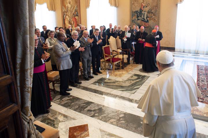 Pope Francis enters the room