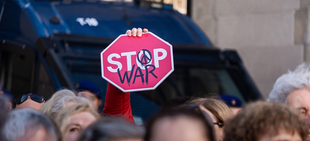 A protestor holds up a sign during a rally in Spain for the end to the war in Palestine. Illustration: Getty Images