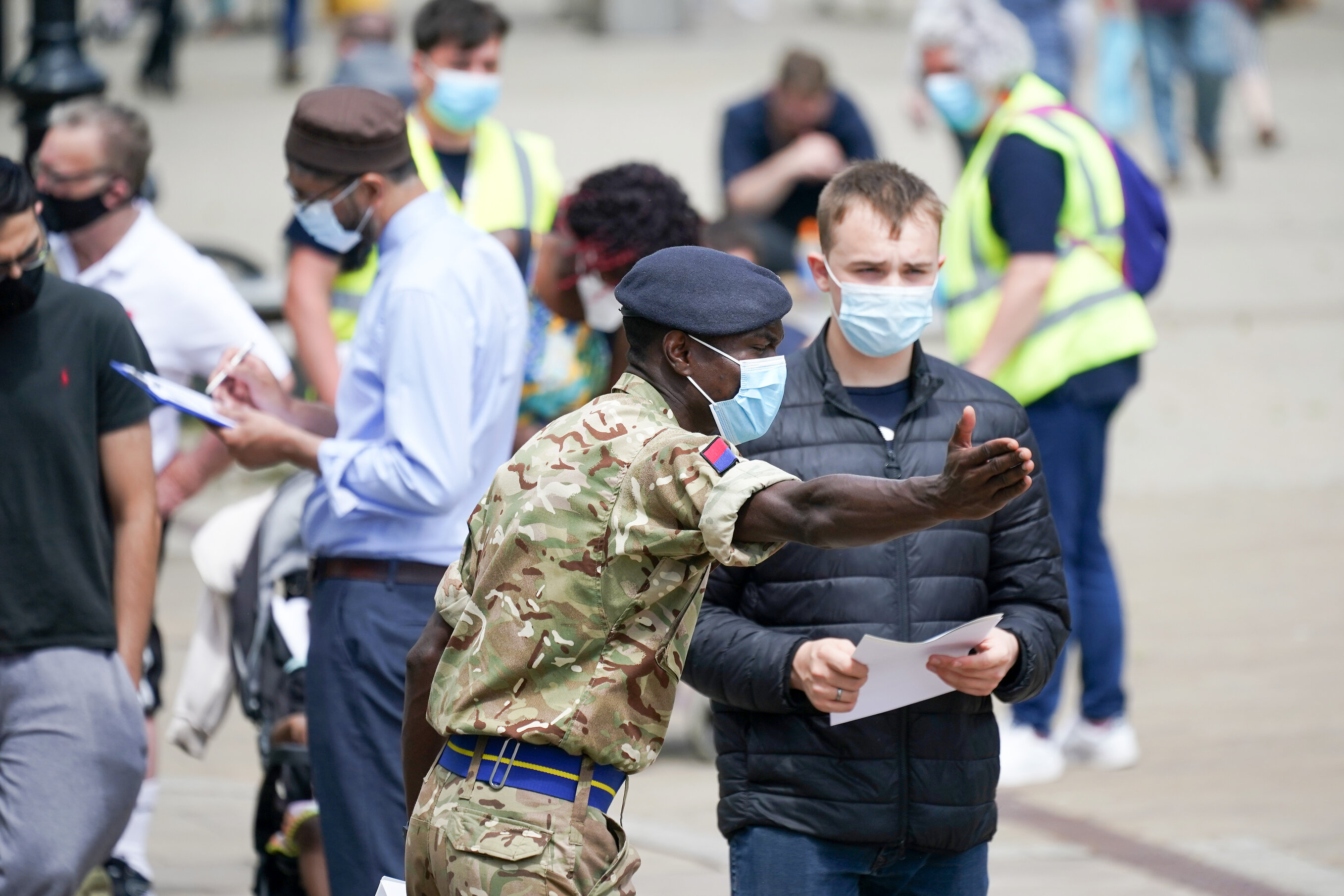 Soldiers guide members of the public at a rapid vaccination centre in June 2021 in Bolton, England. Photo: Christopher Furlong/Getty Images