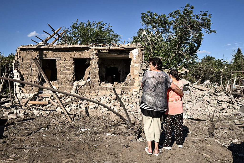 Two women face a house destroyed by a Russian air-bomb strike, Zaporizhzhia, Ukraine, 2026. Photo: Getty Images