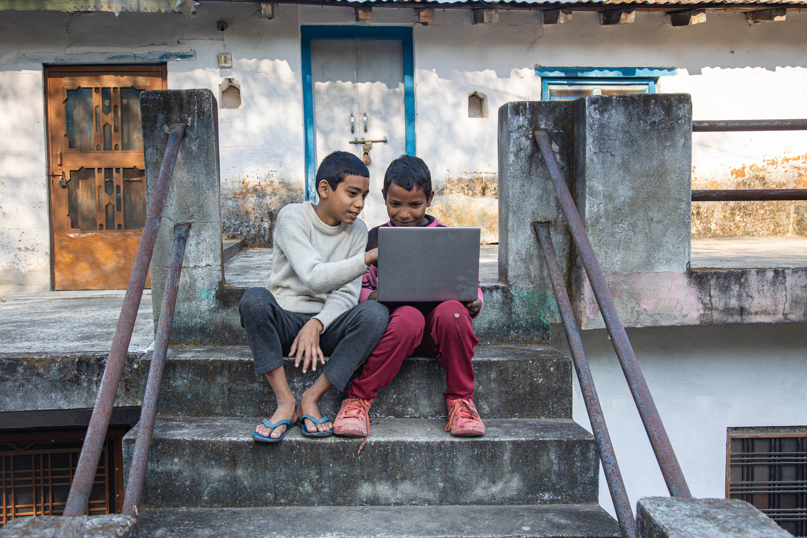 Boys with laptop in rural India. Photo: Umesh Negi / Getty Images