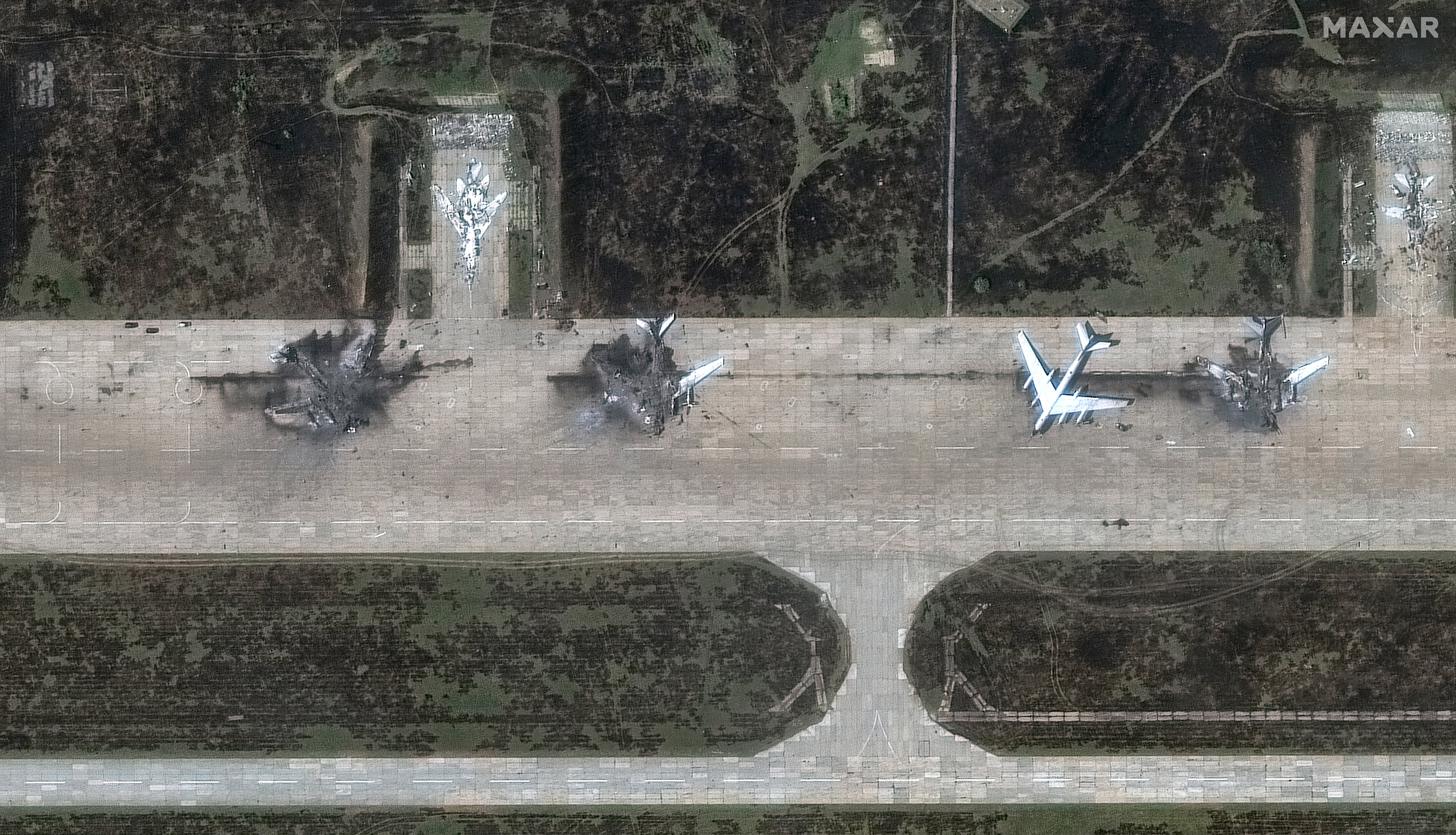 Aftermath of a June 2025 drone strike shows destroyed Tu-95 bombers on the tarmac at Belaya Airbase, Russia. Satellite image. Photo: Maxar Technologies via Getty Images