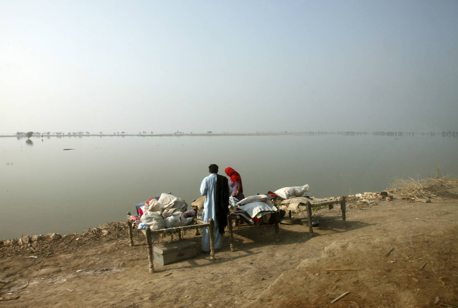 Families returning to their communities following the flooding in Pakistan are often being forced to camp by the roadside, as the flood waters have still not receded sufficiently for them to return to their homes.