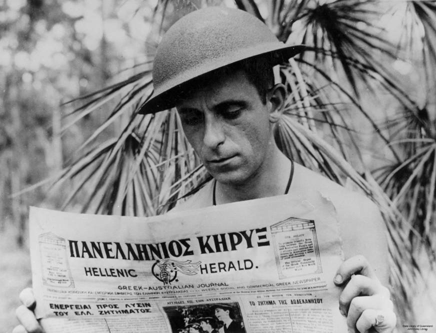 Soldier reading newspaper during World War II. Wikimedia Commons